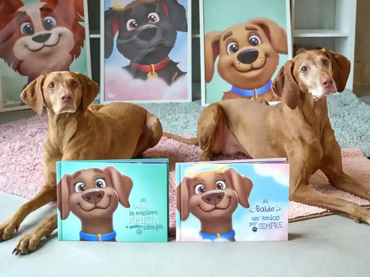 Due cani Vizsla accanto a libri personalizzati di Urrà Eroi con "Kira, la migliore amica a quattro zampe" e "Baldo un' amico per sempre" sulle copertine