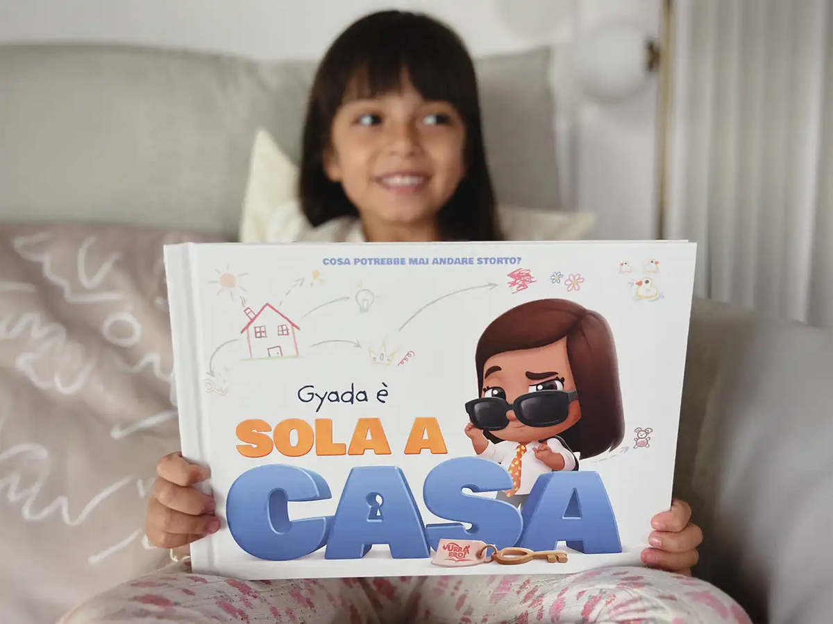 Una bambina con in mano il suo libro personalizzato sullo stare a casa da sola.