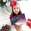 Bambina con fiocco rosso tiene il libro “Il nostro Primo Natale 2025” con Maya & Babbo, un dolce regalo di Natale per papà.